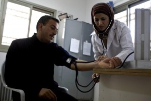 nurse-checking-patients-in-a-community-clinic-west-bank-gaza-improving-community-health-725x483